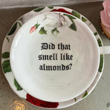 "Did that smell like almonds?" cup and saucer set, porcelain