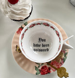 "You have been poisoned" porcelain teacup and saucer set with spoon, 7 ounces