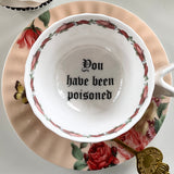 "You have been poisoned" porcelain teacup and saucer set with spoon, 7 ounces