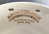 Black and gold Ouija board and planchette cup and saucer set, 12 ounces